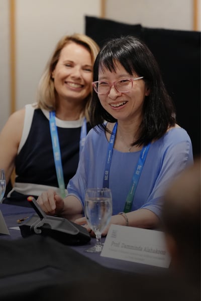 Delegates smiling at a roundtable discussion