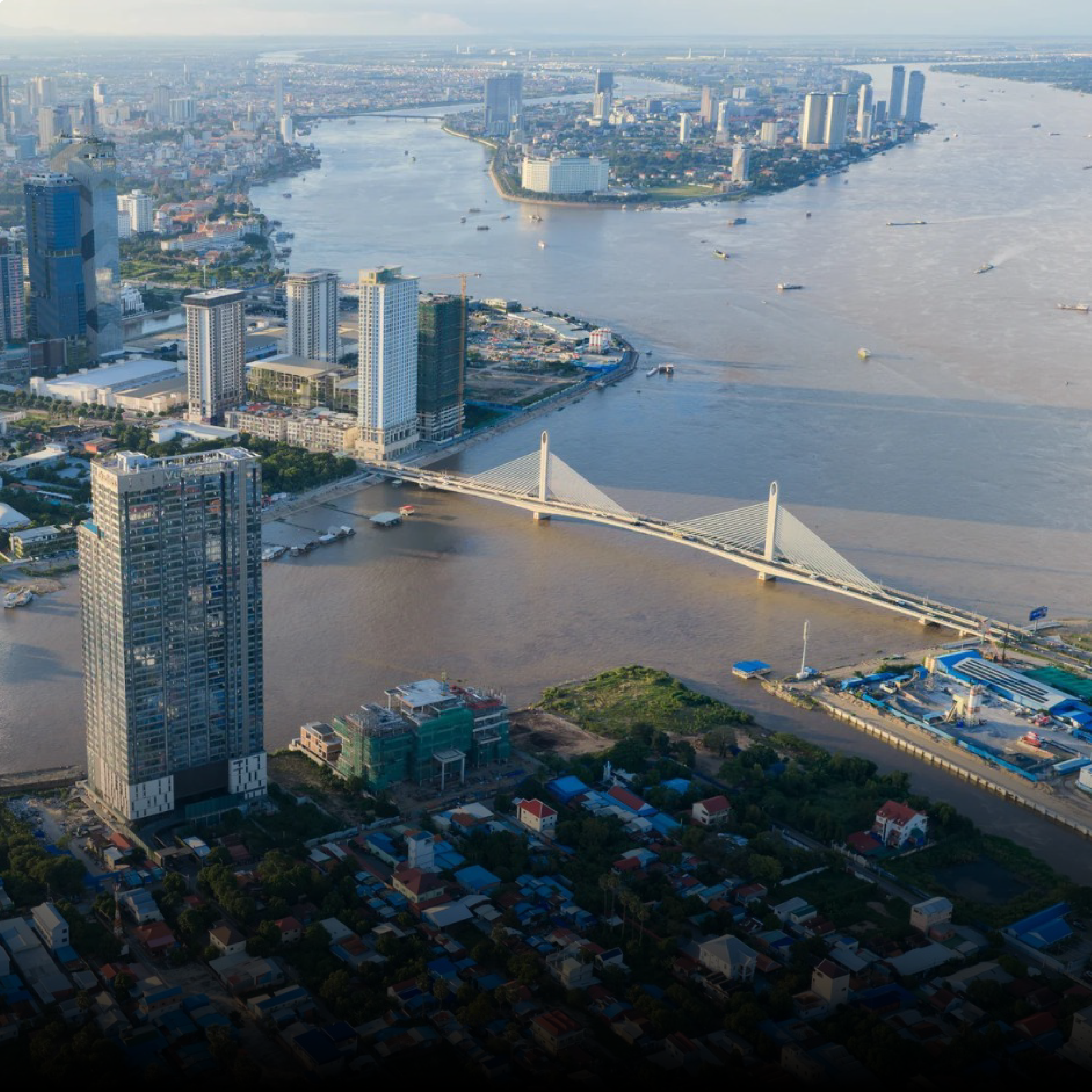 Phnom Penh from above, where the rivers meet, with a cable-stayed bridge and the city skyline