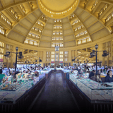 Stalls under the yellow dome of a Phnom Penh market hall